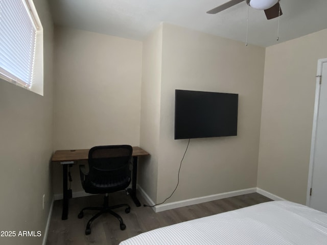 bedroom featuring ceiling fan and dark wood-type flooring