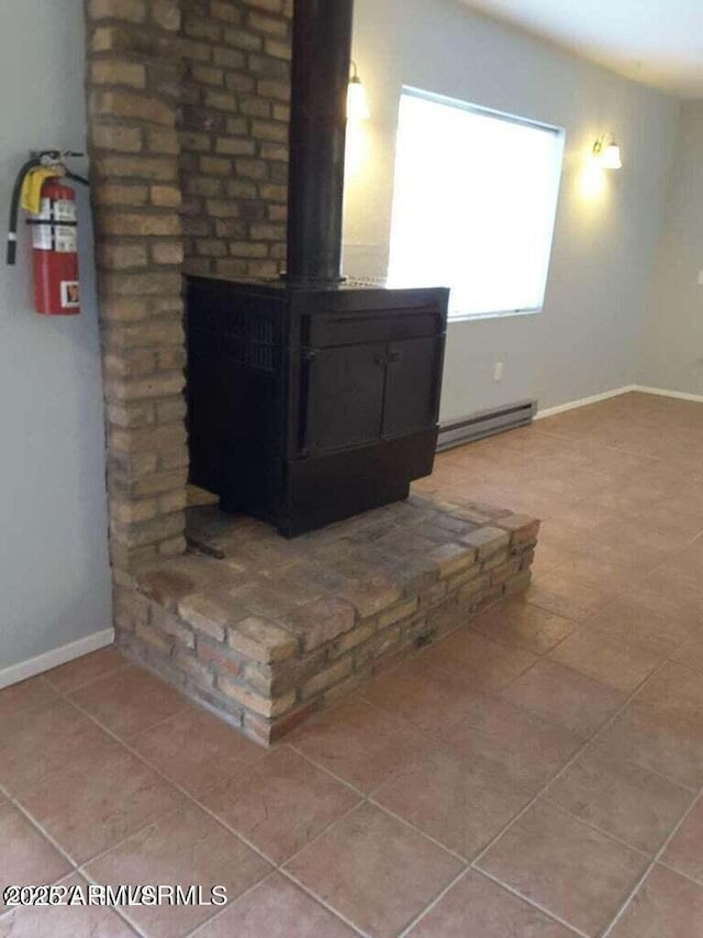 details featuring a wood stove and baseboard heating