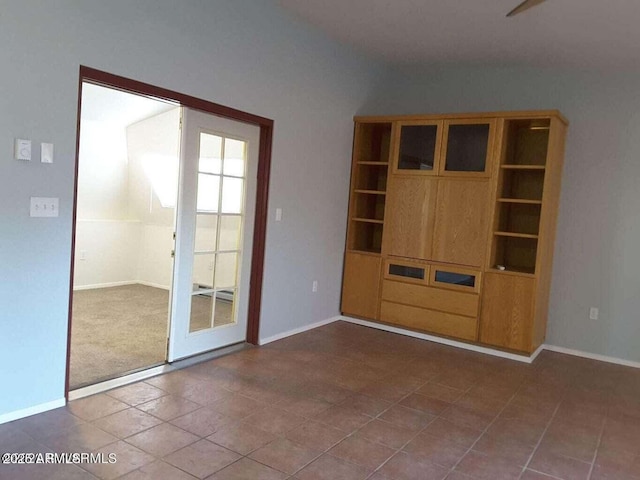 unfurnished living room featuring tile patterned flooring and french doors