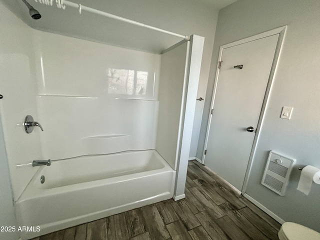 bathroom with wood-type flooring and bathtub / shower combination