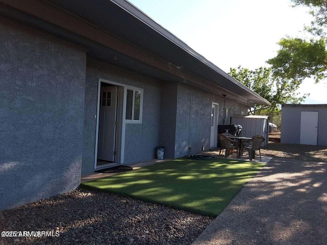 exterior space featuring a shed and a patio