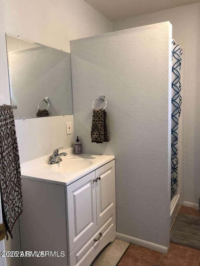 bathroom featuring curtained shower, tile patterned flooring, and vanity