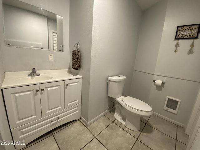 bathroom with tile patterned floors, vanity, and toilet