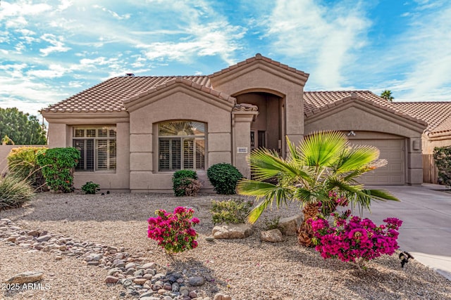 mediterranean / spanish-style home with a garage