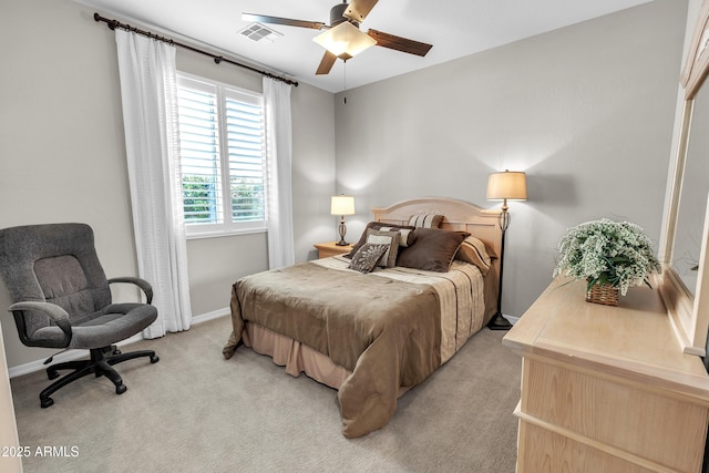 bedroom featuring baseboards, visible vents, a ceiling fan, and light colored carpet