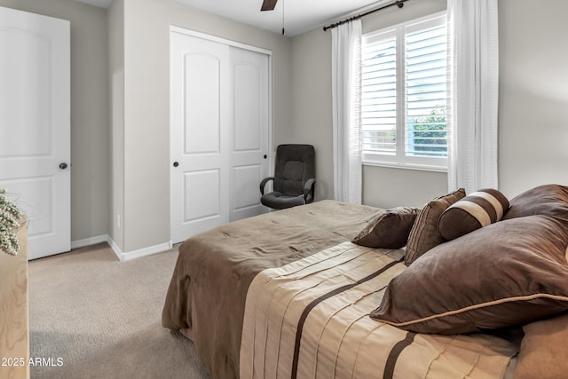 carpeted bedroom with baseboards, a ceiling fan, and a closet