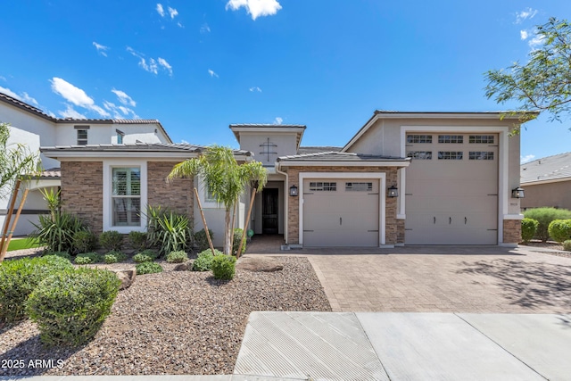prairie-style house with stucco siding, an attached garage, decorative driveway, and a tile roof