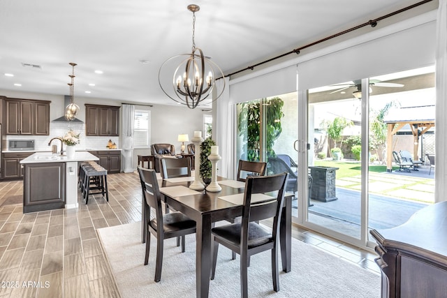 dining room featuring recessed lighting, visible vents, and ceiling fan with notable chandelier