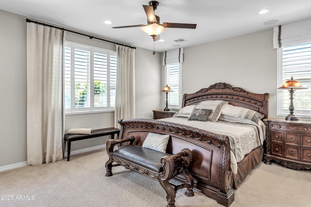 bedroom featuring light carpet, baseboards, and multiple windows