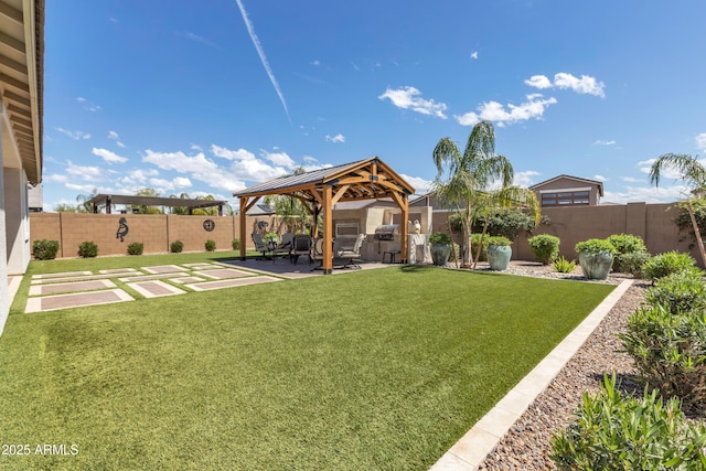 view of yard featuring a patio area, a fenced backyard, and a gazebo