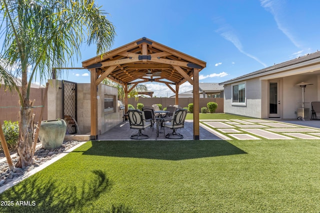 view of yard featuring a fenced backyard, a gazebo, and a patio area