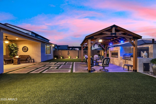 view of yard featuring a fenced backyard, a gazebo, area for grilling, a patio, and an outdoor fire pit