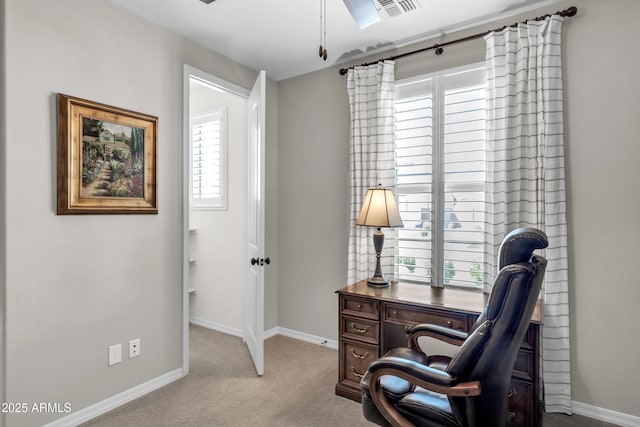 carpeted office with visible vents and baseboards