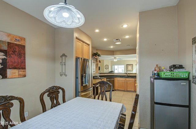 dining room with light tile patterned flooring, ceiling fan, and sink