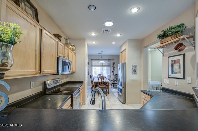 kitchen featuring stainless steel appliances, light brown cabinetry, sink, and hanging light fixtures