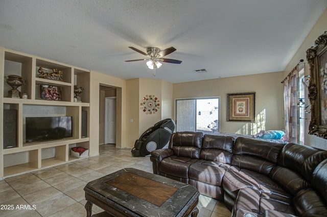 living room with ceiling fan and light tile patterned flooring