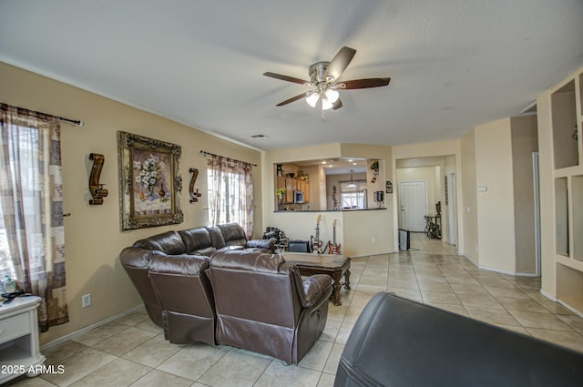 living room with ceiling fan and light tile patterned floors