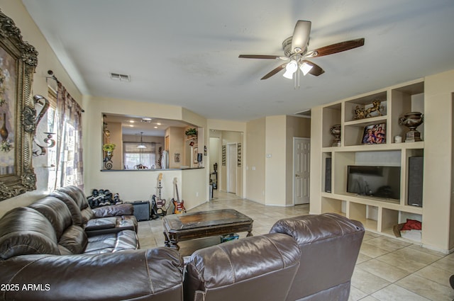 living room featuring ceiling fan, built in features, and light tile patterned floors