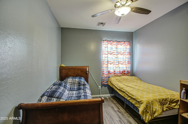 bedroom featuring hardwood / wood-style flooring and ceiling fan