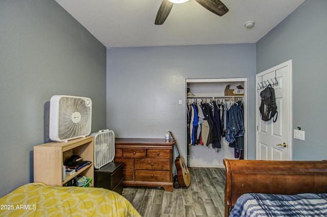 bedroom featuring hardwood / wood-style flooring, a closet, and ceiling fan