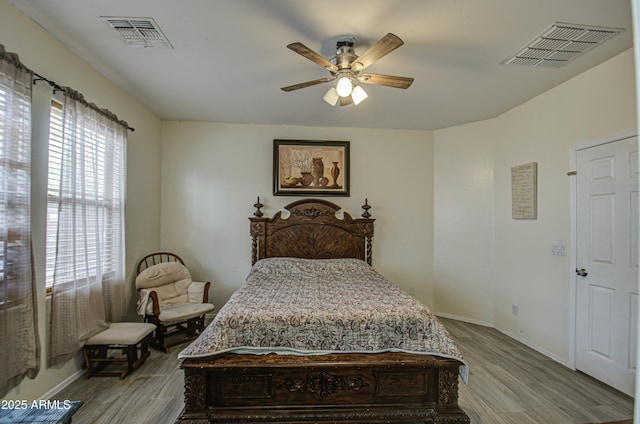 bedroom with light hardwood / wood-style floors and ceiling fan