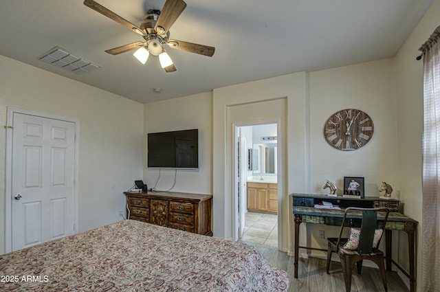 bedroom with ensuite bathroom, ceiling fan, and light wood-type flooring