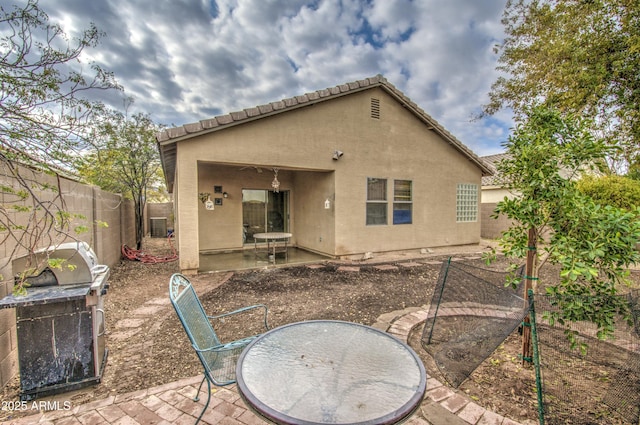 back of house featuring central AC and a patio area