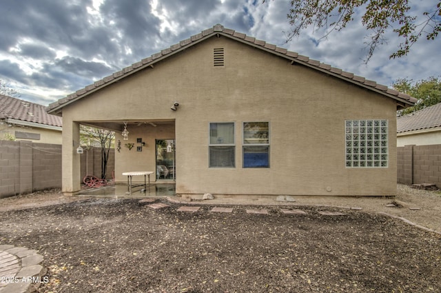 back of property with a patio