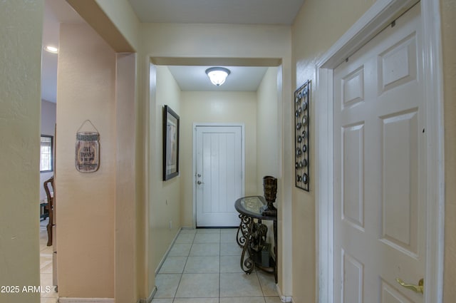 hall featuring light tile patterned flooring