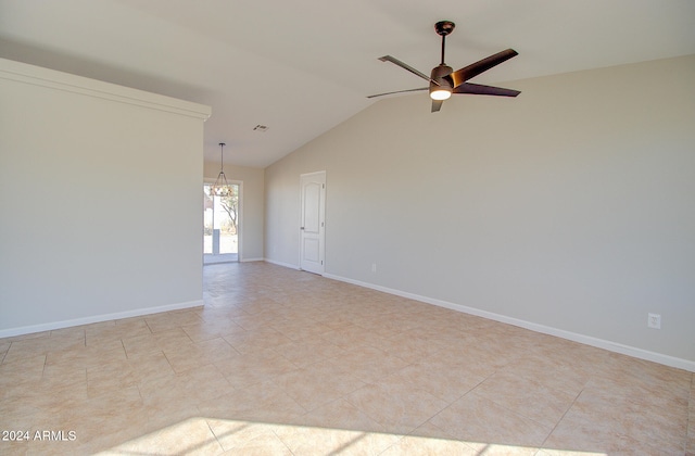 tiled empty room with ceiling fan with notable chandelier and lofted ceiling