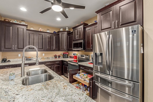 16259 W Papago St, Goodyear, AZ 85338 - kitchen featuring stainless steel appliances, dark brown cabinetry, ceiling fan, light stone countertops, and recessed lighting