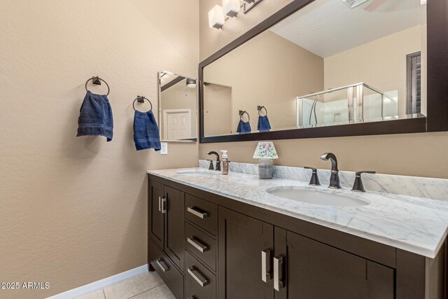 16259 W Papago St, Goodyear, AZ 85338 - full bathroom featuring double vanity, a shower stall, and tile patterned floors