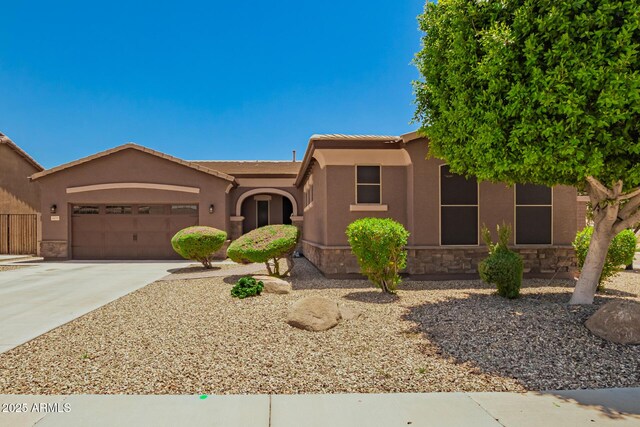 16259 W Papago St, Goodyear, AZ 85338 - view of front of property with an attached garage, concrete driveway, and stucco siding