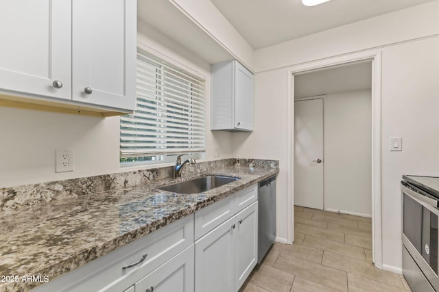 kitchen featuring stainless steel appliances, light stone countertops, sink, and white cabinets