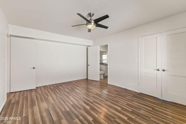 unfurnished bedroom with dark hardwood / wood-style floors, connected bathroom, ceiling fan, and a closet