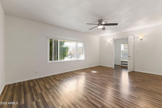 empty room featuring dark hardwood / wood-style flooring and ceiling fan