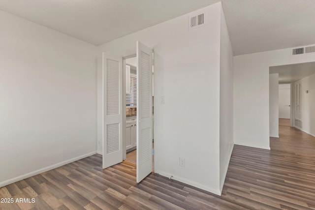 unfurnished bedroom featuring dark wood-type flooring