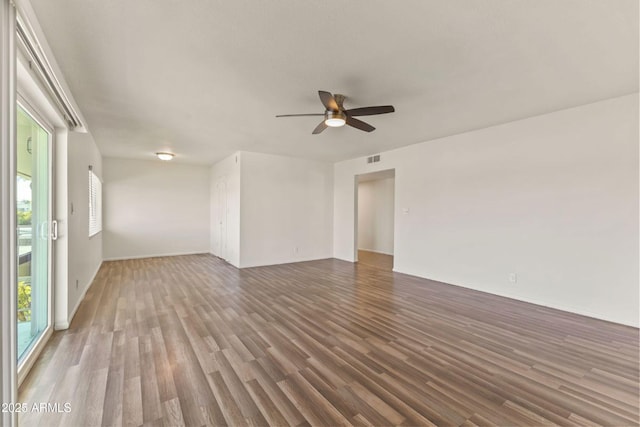 empty room with hardwood / wood-style flooring and ceiling fan