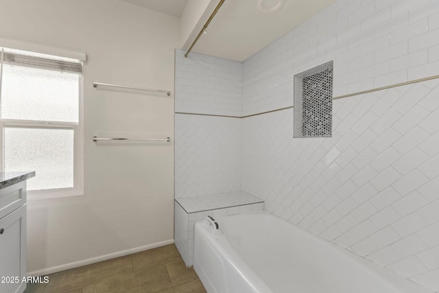 bathroom with vanity, a tub to relax in, and tile patterned floors