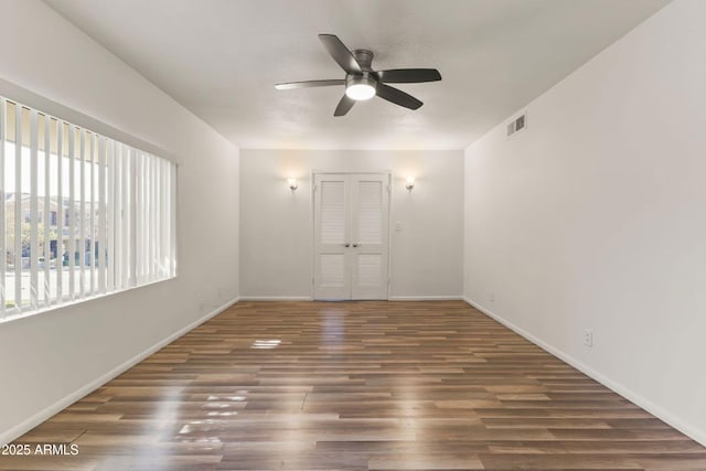 spare room featuring ceiling fan and dark hardwood / wood-style flooring