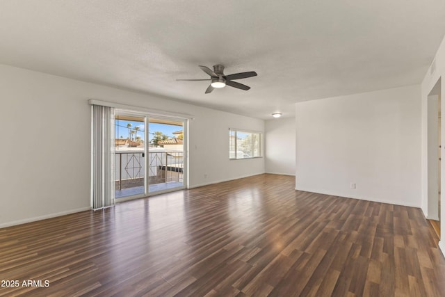 spare room with a textured ceiling, dark hardwood / wood-style floors, and ceiling fan