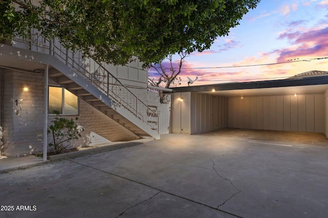 patio terrace at dusk featuring a carport