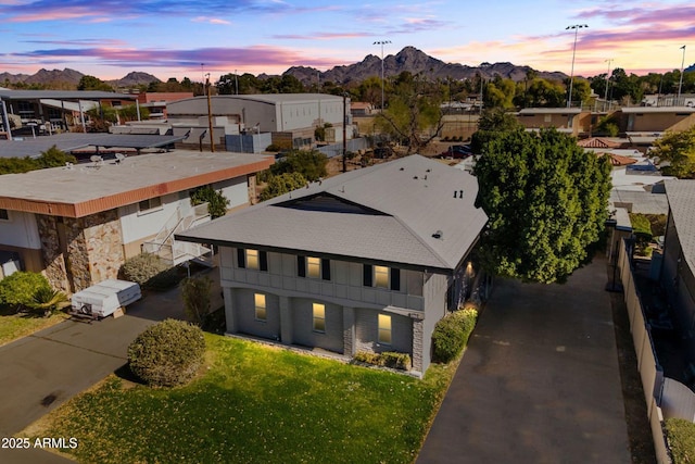 aerial view at dusk featuring a mountain view