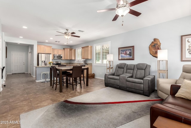 living area with ceiling fan, recessed lighting, and baseboards
