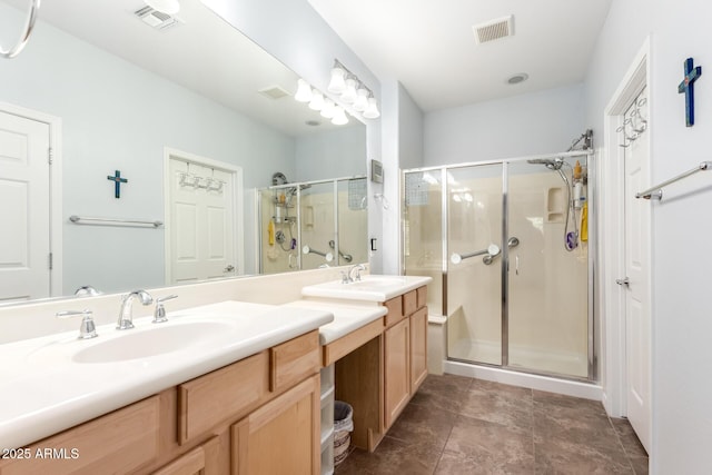 full bath featuring a shower stall and double vanity