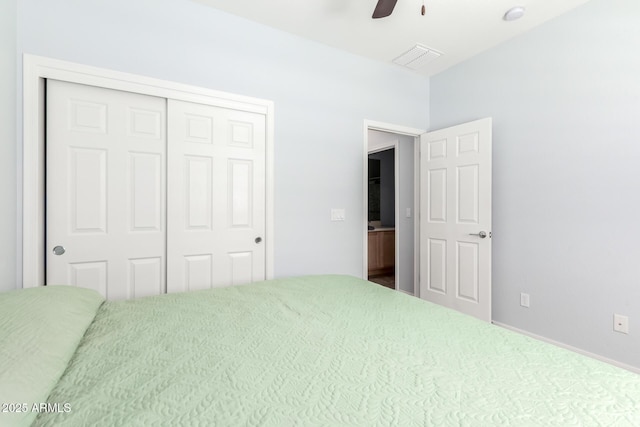 carpeted bedroom featuring a closet and ceiling fan