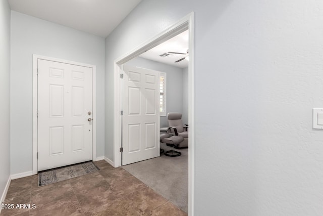 entrance foyer featuring baseboards and ceiling fan