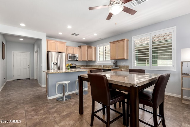 dining space with baseboards, a ceiling fan, and recessed lighting