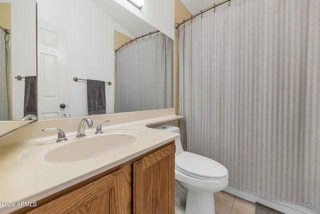 bathroom with tile patterned flooring, vanity, and toilet