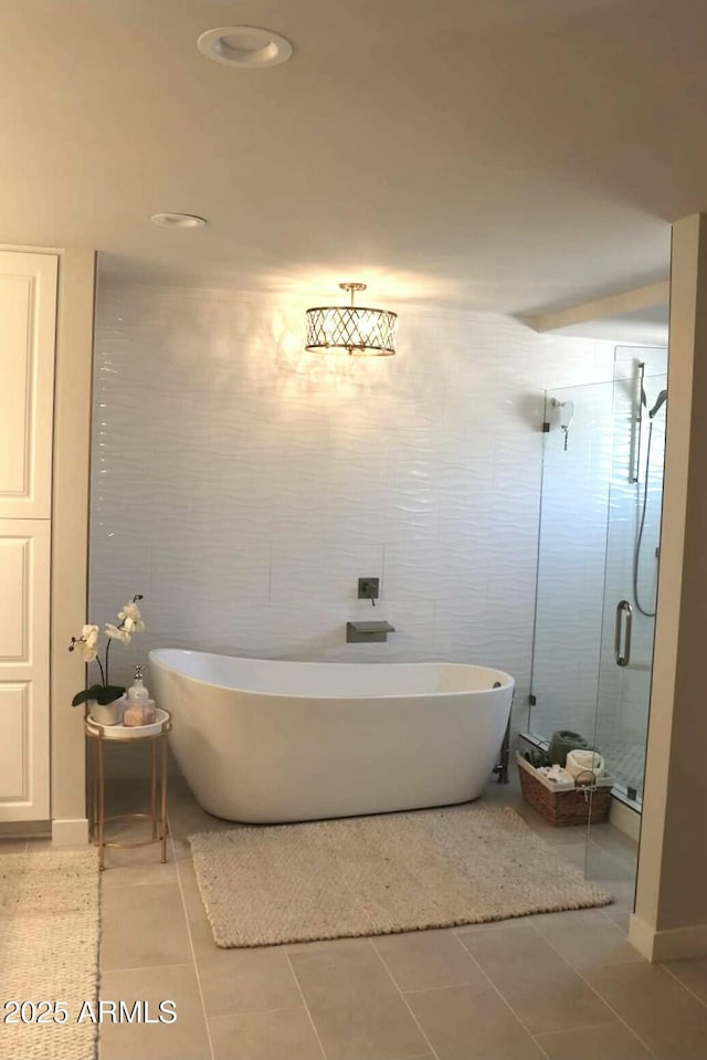 bathroom with tile walls, plus walk in shower, and tile patterned flooring